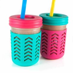 2 smoothie cups filled with a hidden veggie smoothie for kids and toddlers.