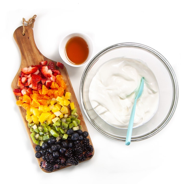 Ingredients for Rainbow Yogurt Bark spread on a white background. 