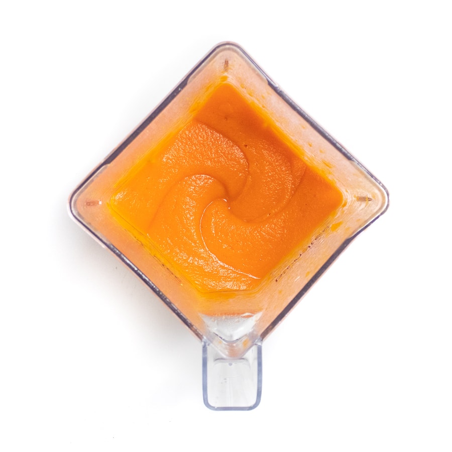 A blender with puréed cooked carrots.