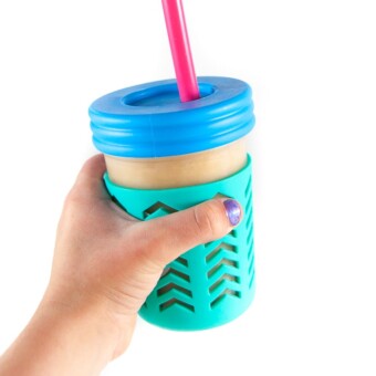 Hands holding up smoothie cup.