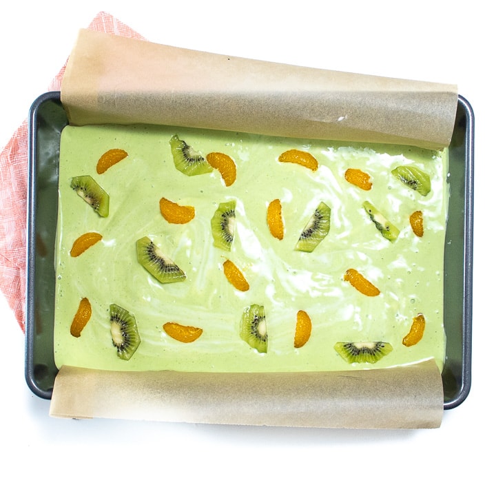 baking sheet full of green yogurt and fruit.