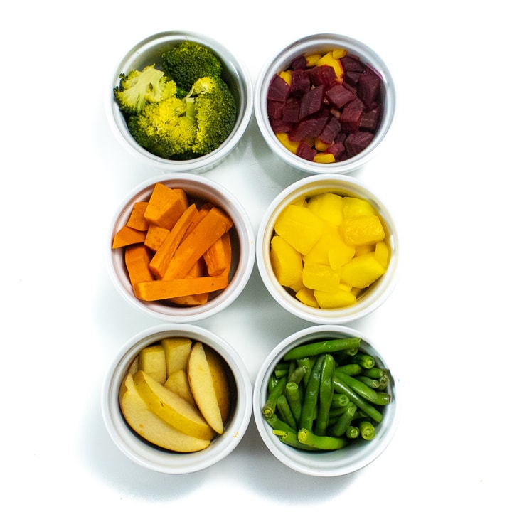 6 ramekins with different fruits and vegetables for baby food.