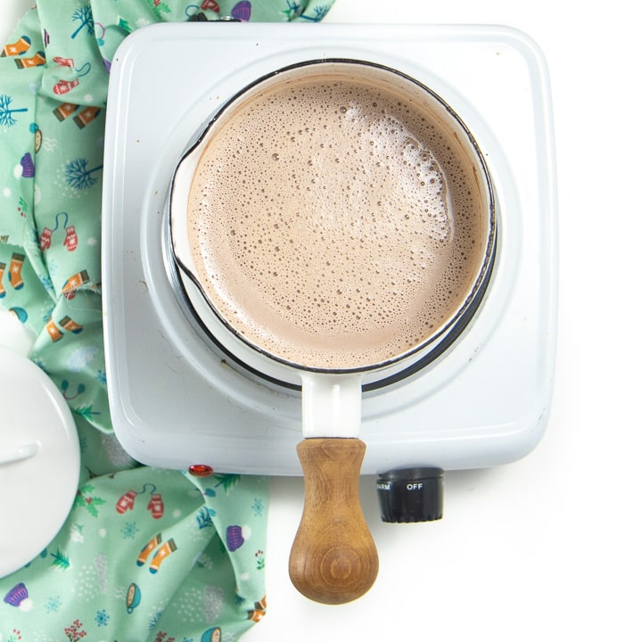 Small saucepan with warm hot chocolate ready to serve.