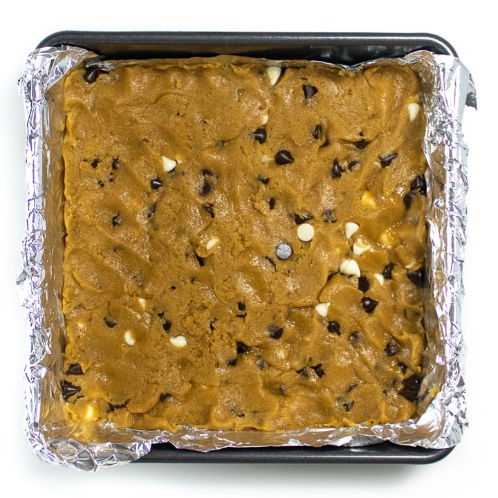 Cookie bar dough pressed into a baking pan.