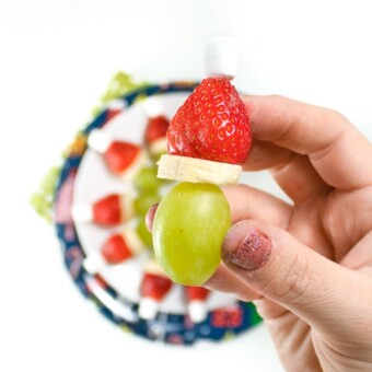 Hand holding up a grinch kabob.