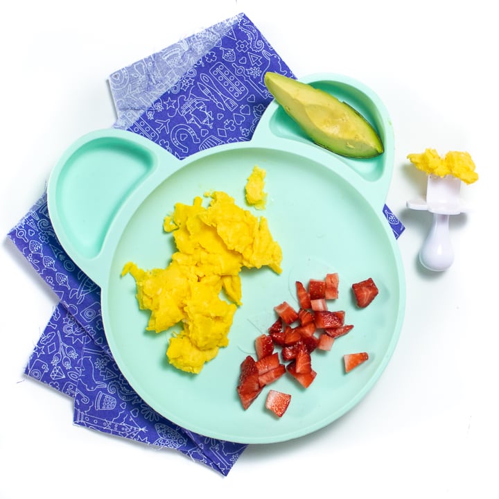 Teal plate with scrambled eggs for babies. 