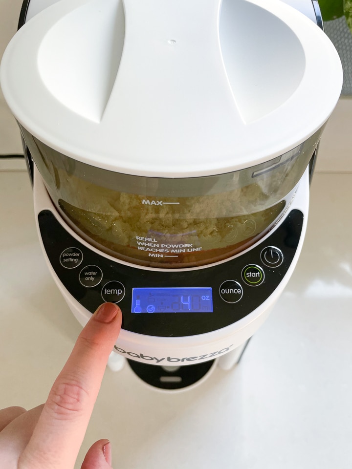 Finger pointing to the temperature setting on the baby Brezza.