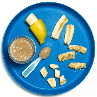 A blue plate with different ways to serve banana to baby. The plate is on my white kitchen counter.