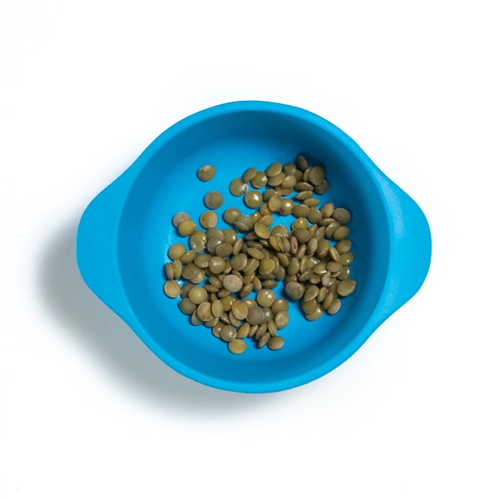 Blue bowl filled with lentils.