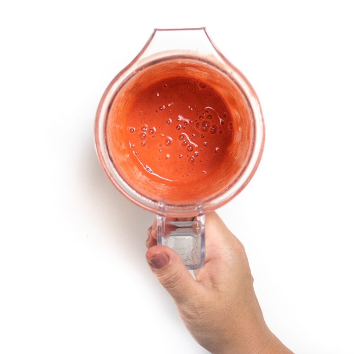 Small blender with pureed strawberries.