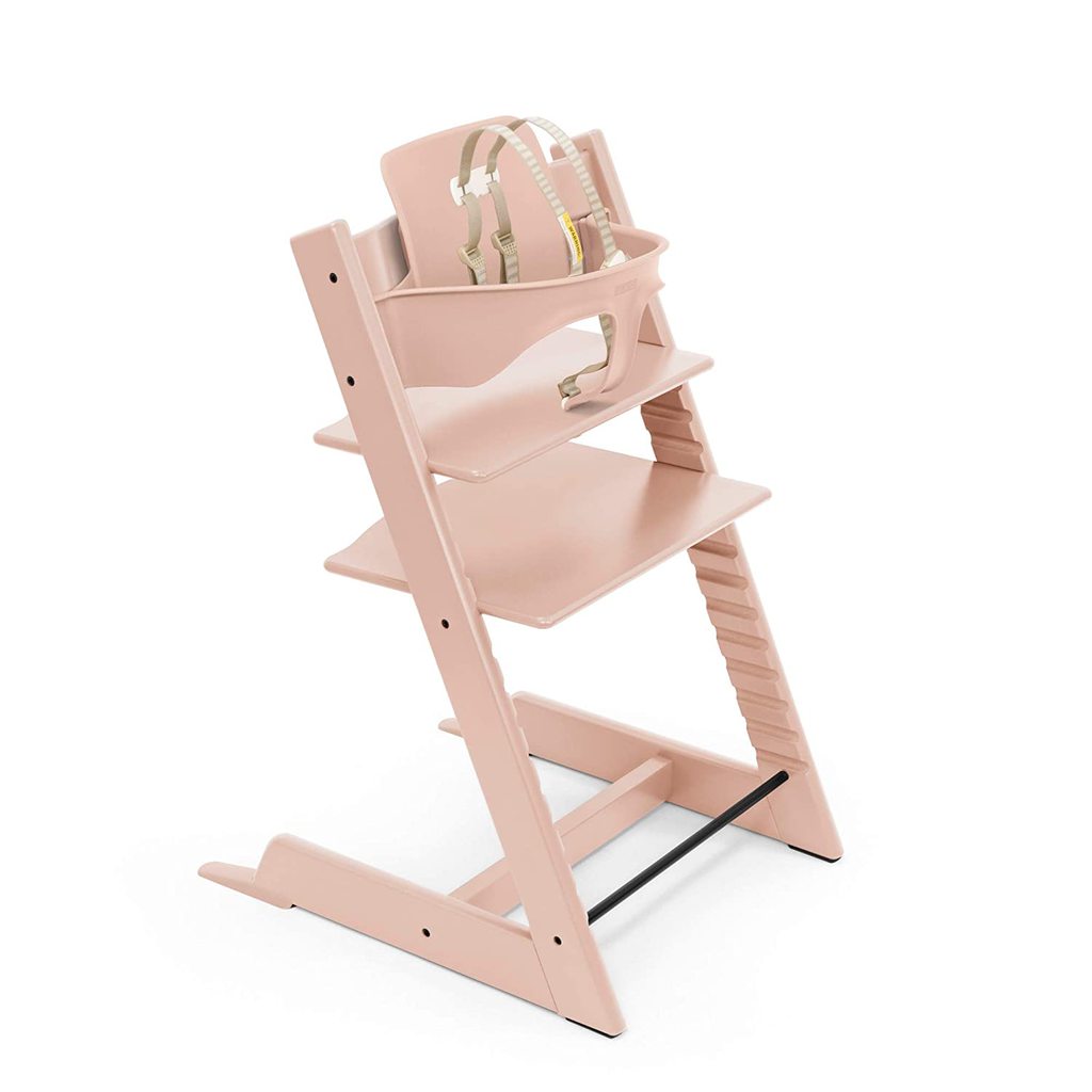 A light pink wooden high chair for baby toddler and kids.