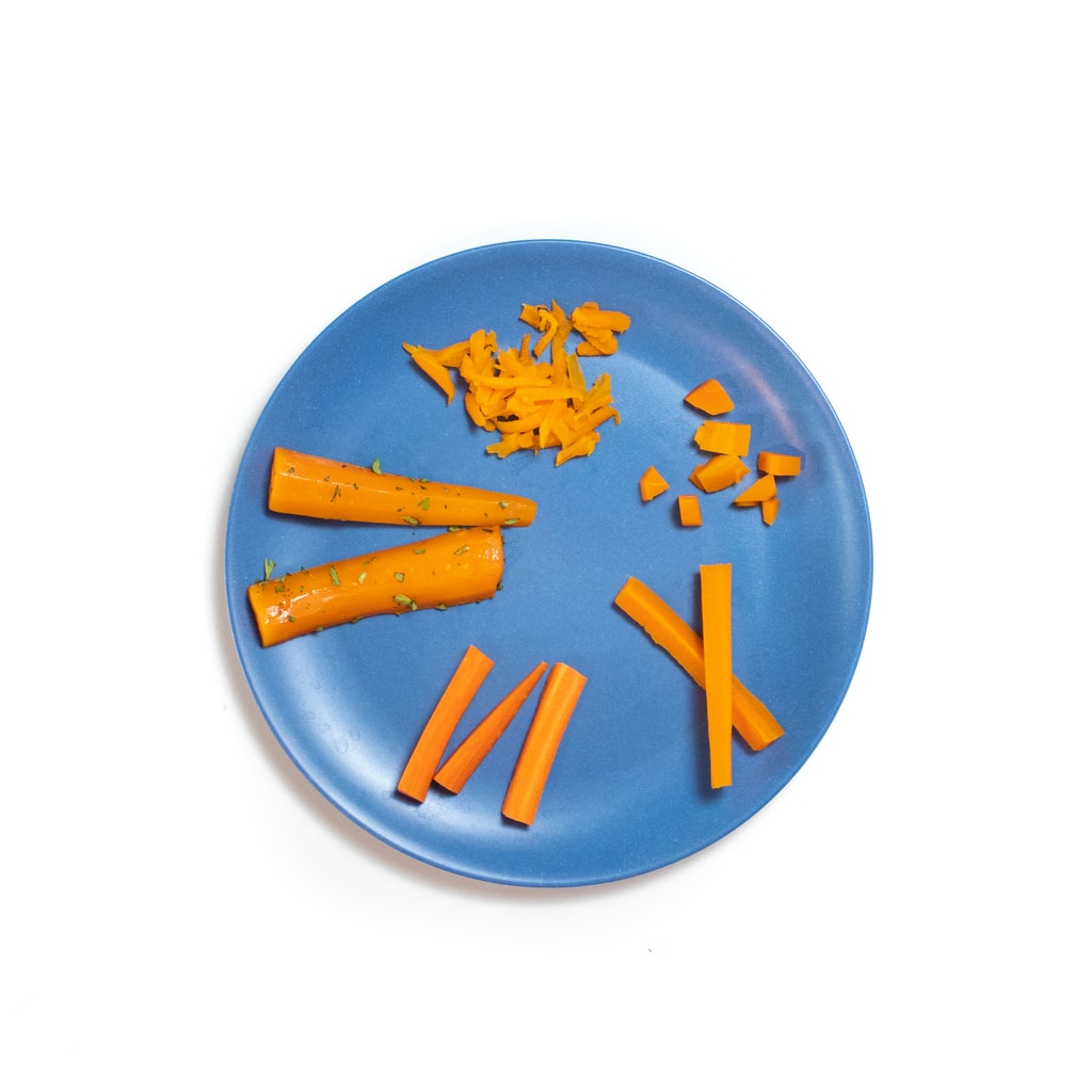 A blue baby plate full of five different sizes for baby led weaning.