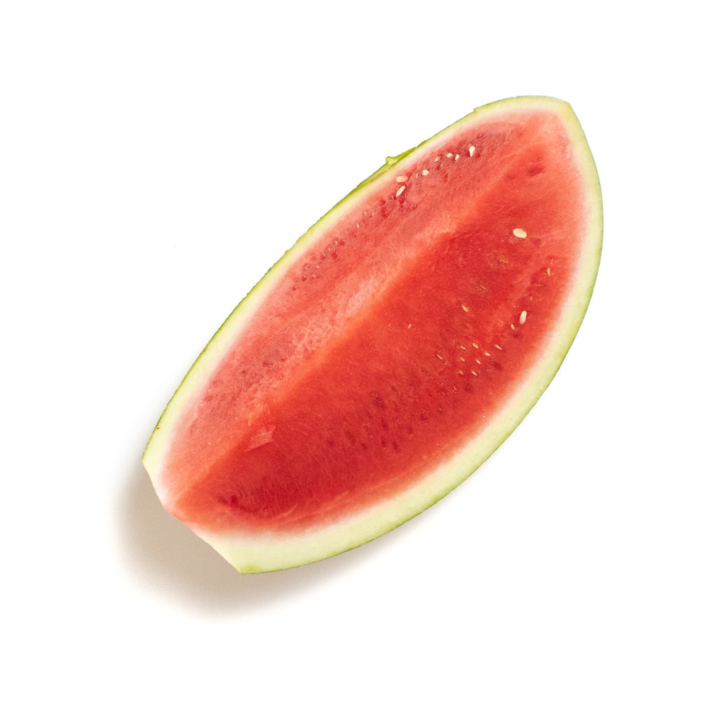 A wedge of watermelon sitting on the white background