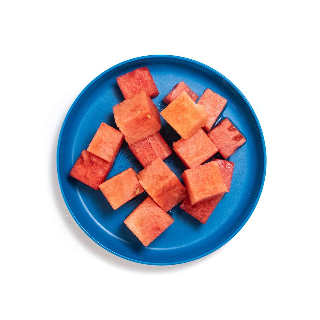 Blue plate with cubes of watermelon.
