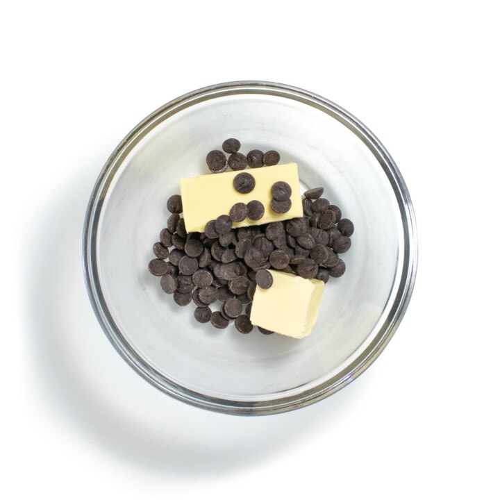 Glass bowl with butter and chocolate chips.