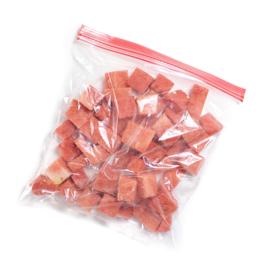 A Ziploc bag full of frozen watermelon cubes.