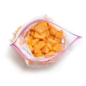 And overhead shot a frozen cantaloupe in a Ziploc bag against a white background.