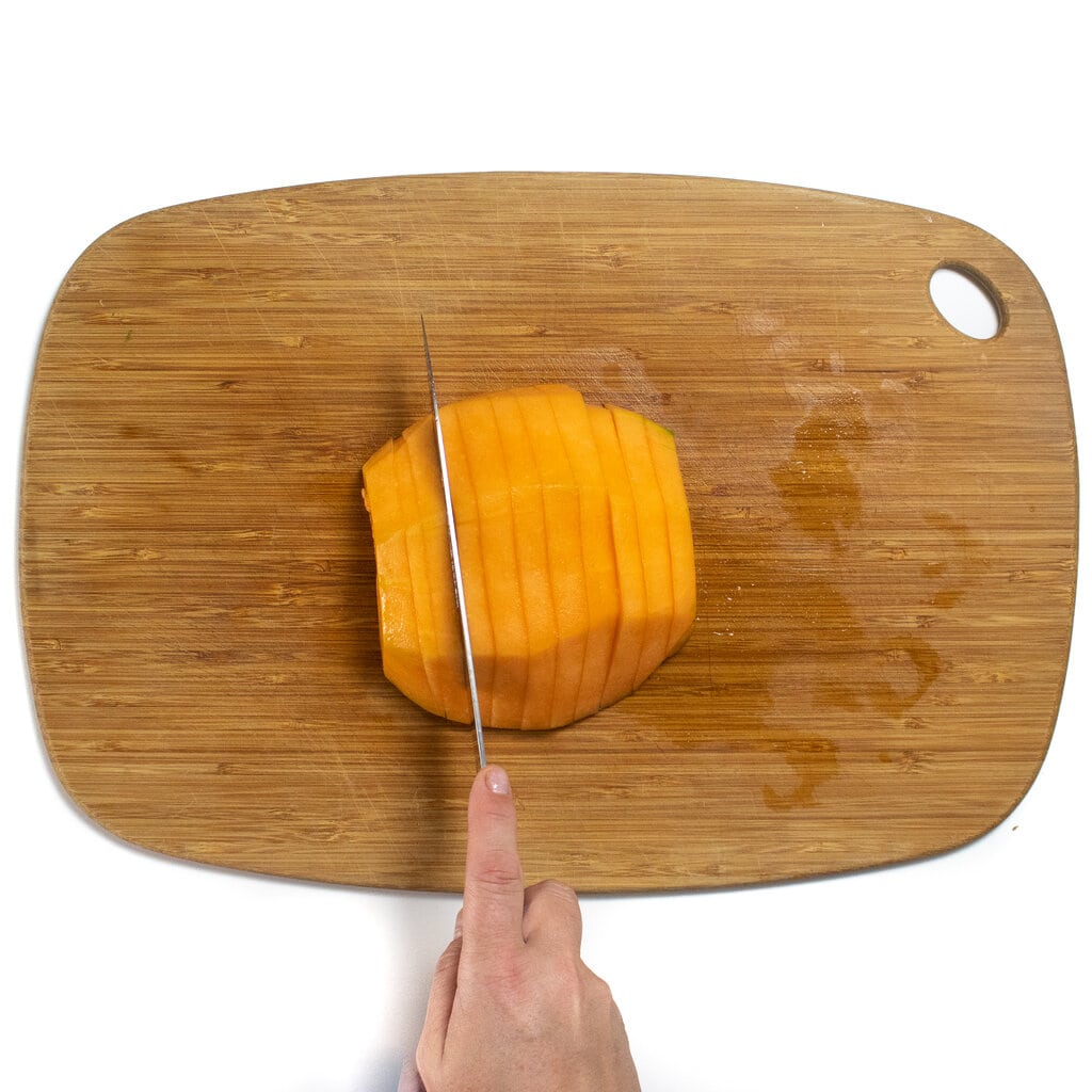 Thinly sliced cantaloupe any wooden cutting board