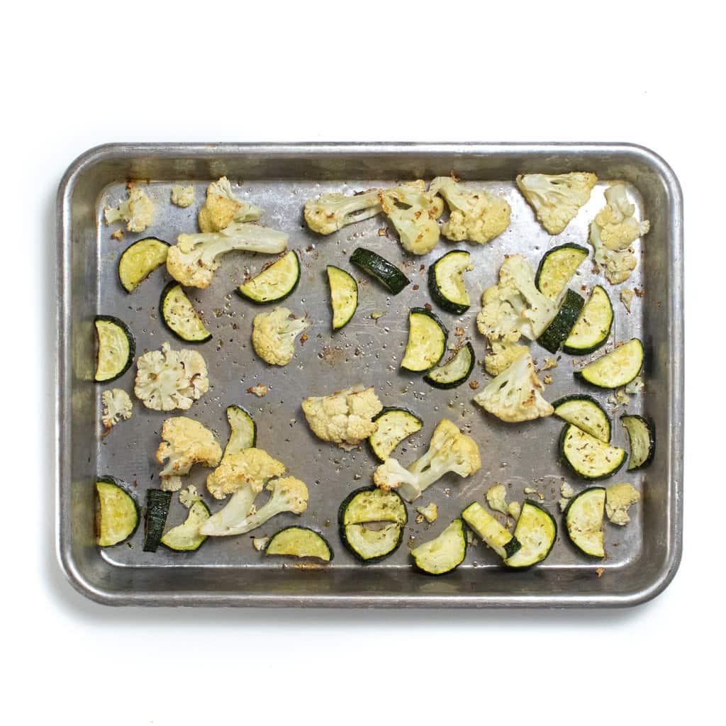 A baking sheet with roasted cauliflower and zucchini for baby food.