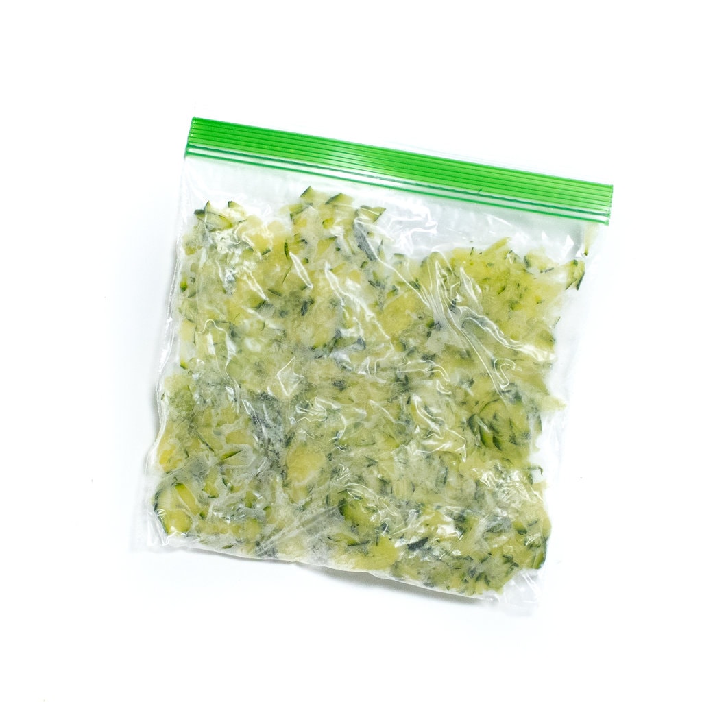 A Ziploc bag full of frozen shredded grated zucchini.