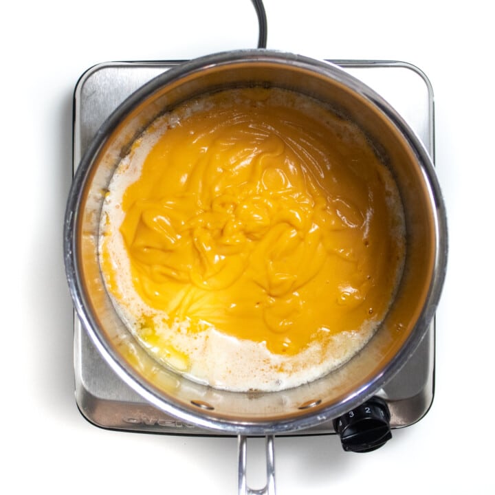 Silver sauce pan with sweet potato purée in butter.