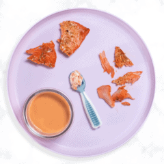 Purple baby plate sitting on my white kitchen counter with roasted salmon for baby.