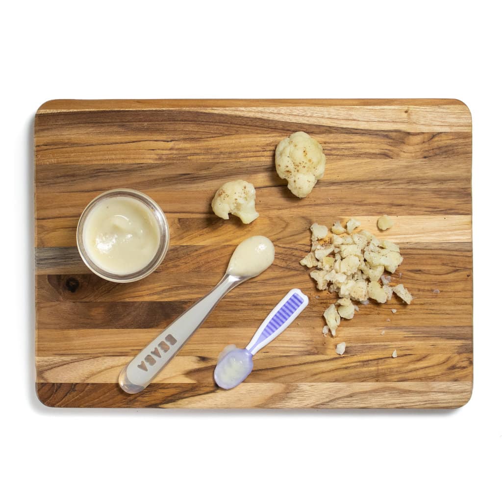 Hey cutting board showing how to feed cauliflower to baby for a purée or baby led weaning.