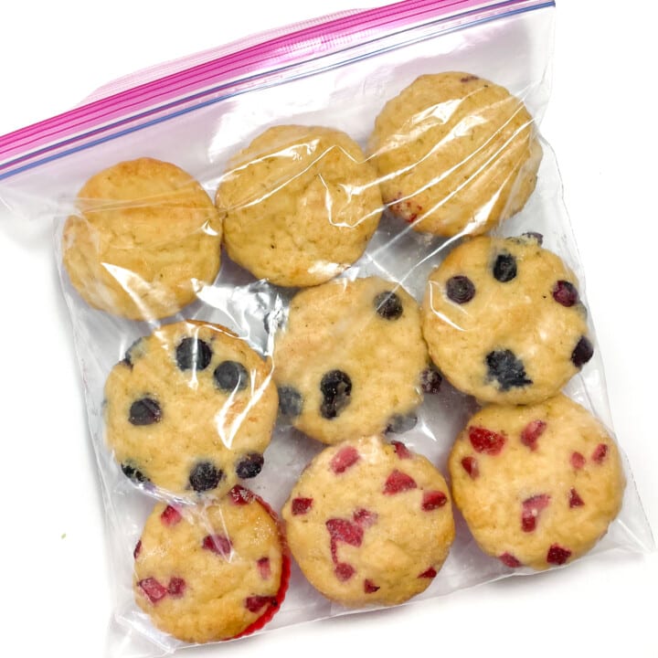 A Ziploc bag full of frozen muffins against a white background.