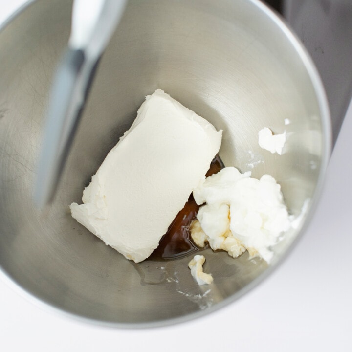 Silver mixing bowl, filled with cream cheese, maple syrup, vanilla and yogurt.