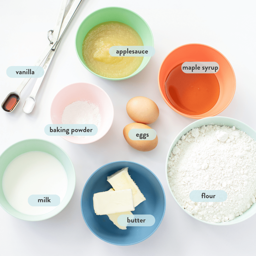 Spread of ingredients in colorful bowls against a white background. 