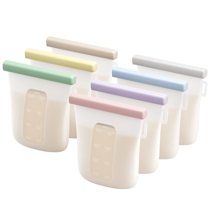 White and clear silicone breast milk storage bags with colorful clasps to close the bags. 