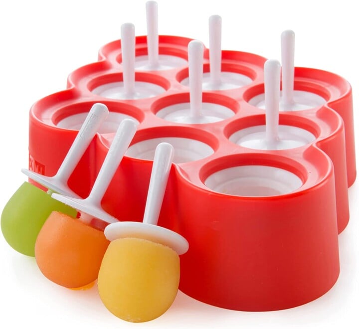 Red mini popsicle tray with white sticks against a white background. 