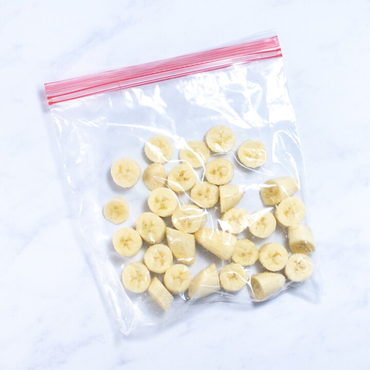 A plastic bag full of sliced banana pieces.