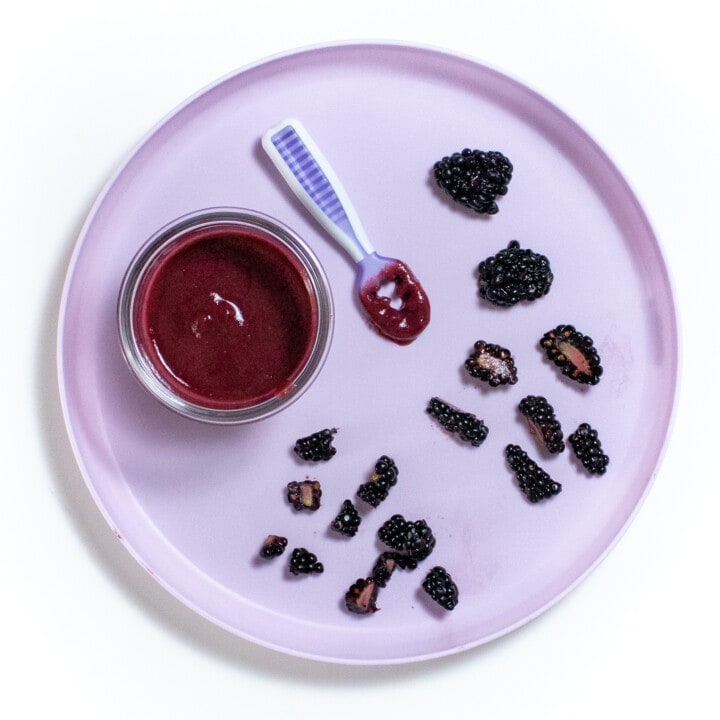 Purple plate with different ways to cut a blackberry for baby.