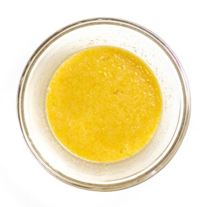 A small Mixing bowl full of wet ingredients for muffins.