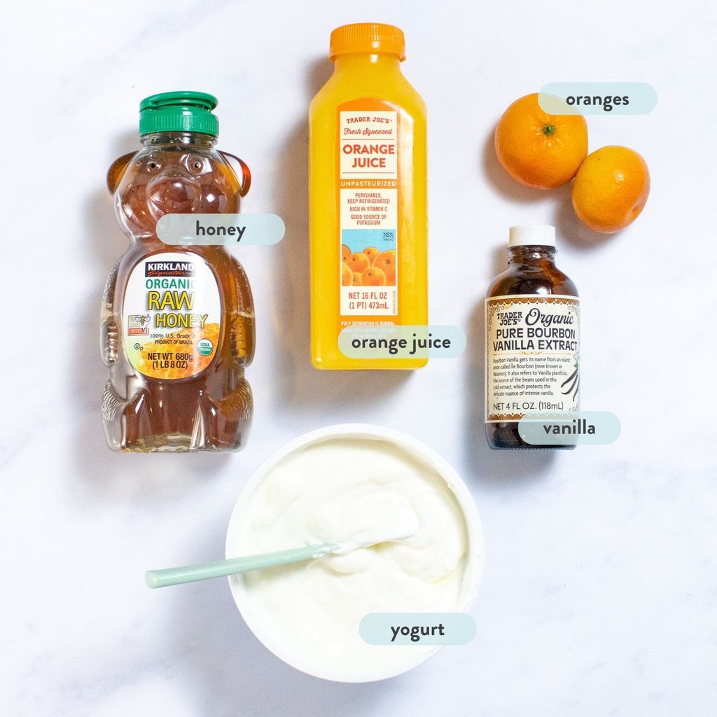 Ingredients for orange Creamsicle's on a white marble countertop.