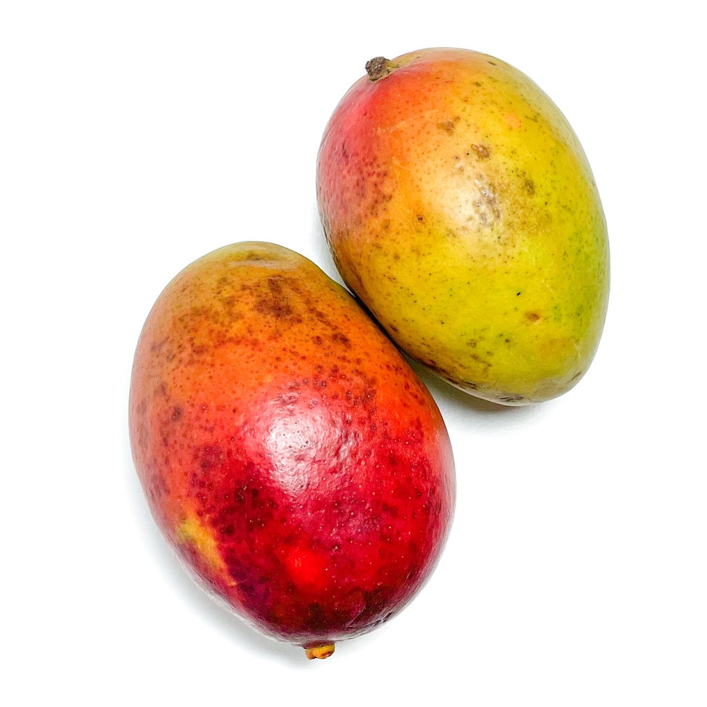 2 mango sitting on a white counter. 