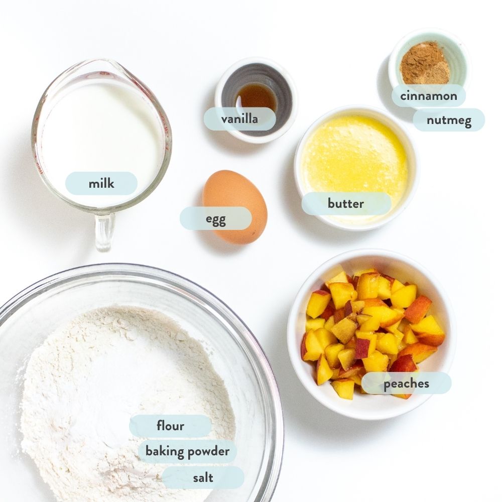 a spread of ingredients for peach pancakes against a white background.