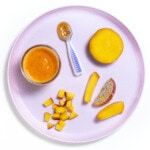 purple kids plate on a white background with several different ways to cut and serve peaches to baby.