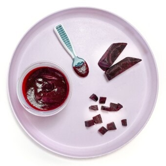 Purple kids plate with different ways to cut and serve beets to your baby, on a white countertop.