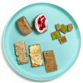 Image is of blue baby plate with different sizes and toppings on how to serve bread and toast to baby.