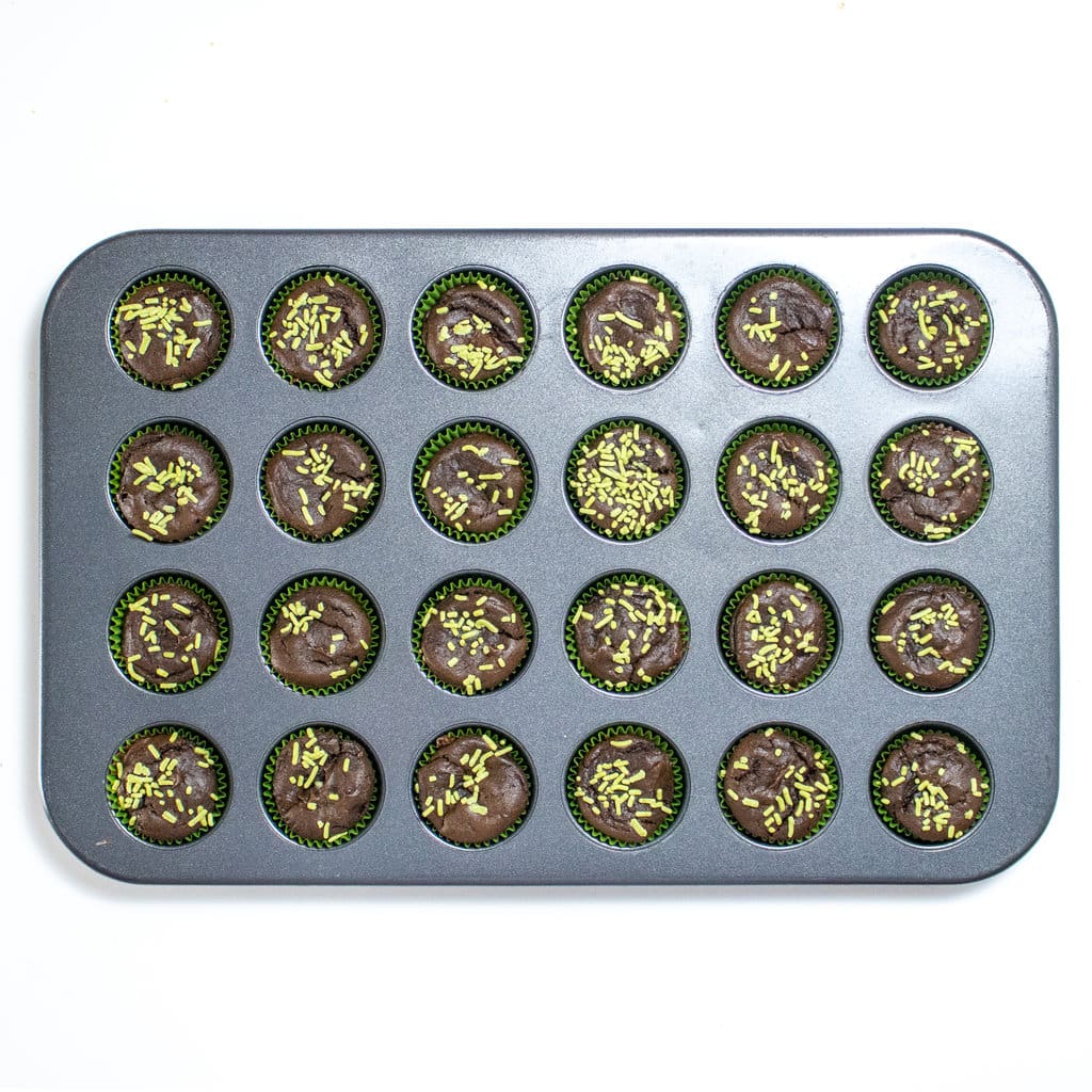 A tray of mini avocado brownie bites against a white background.