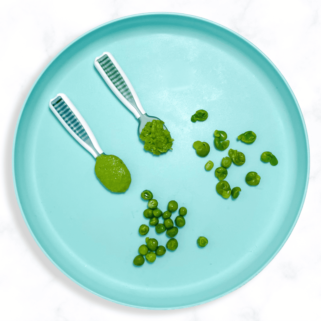 Blue baby plate sitting on a white kitchen counter showing different ways to serve peas to your baby. 
