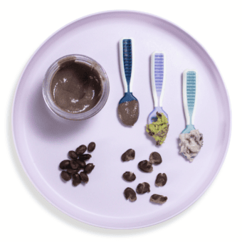 Purple baby plate showing different baby foods.
