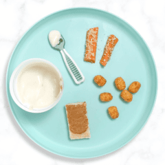 Teal baby plate on a white marble kitchen counter showing different ways to serve peanuts to your 6-12 month your old.