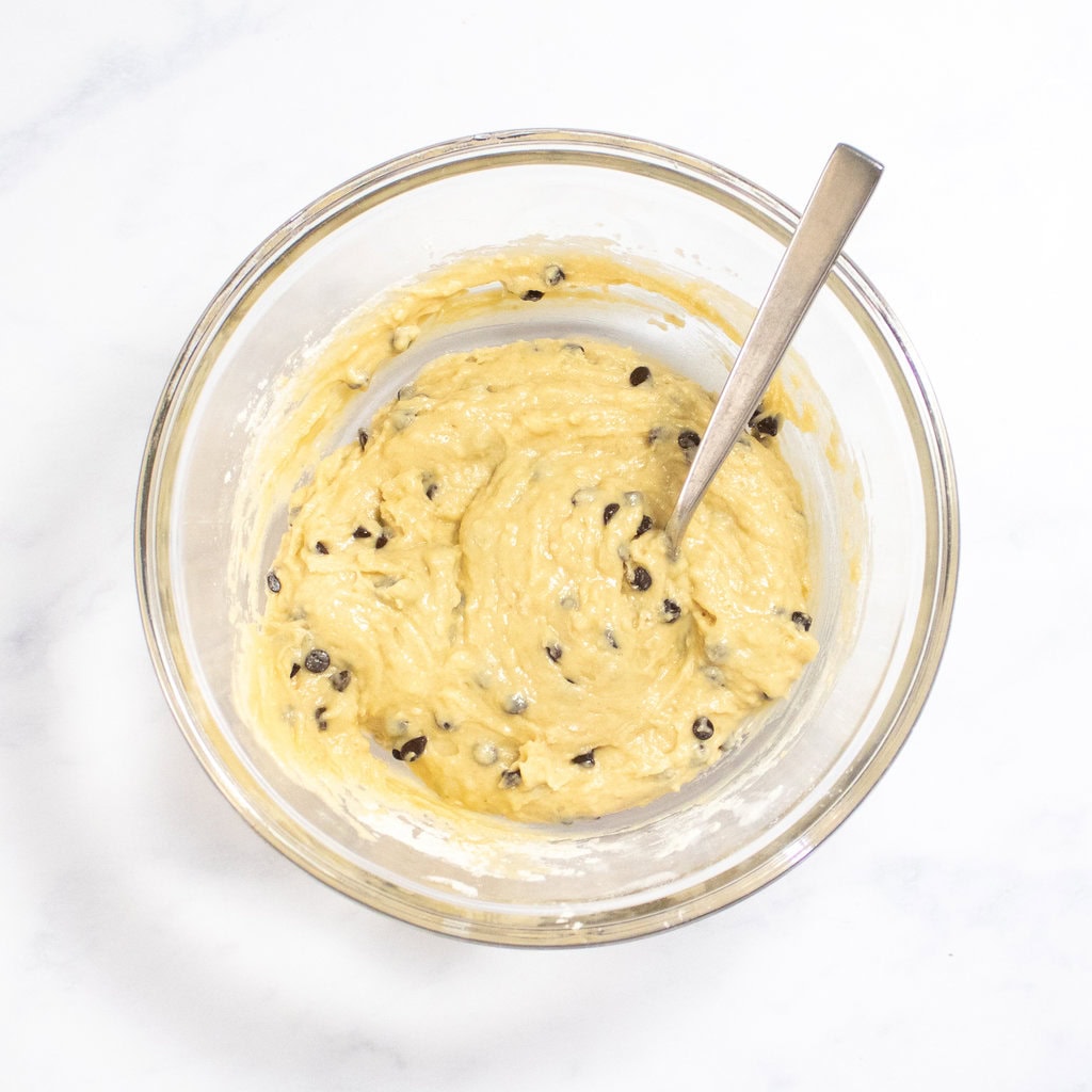 Mixed batter for chocolate chip muffins sitting on my white marble counter. 